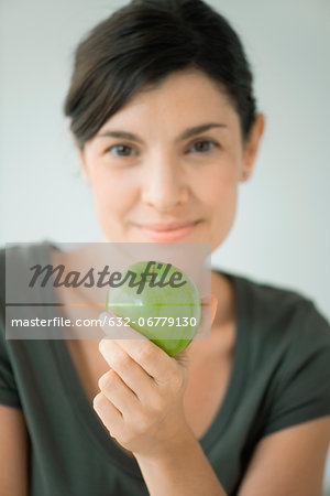 Woman holding green apple