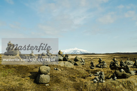 Cairns volcanic stone on a background of snowy mountains, Iceland Gullfoss