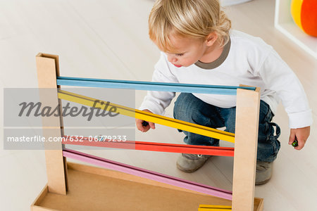 Baby watching marble rolling down bars