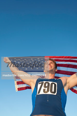 Male athlete holding up American flag