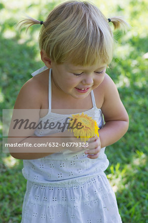 Little girl holding flower, portrait