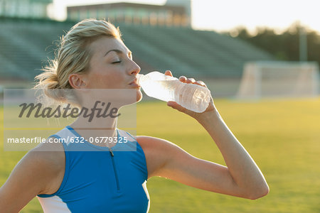 Female athlete drinking bottled water