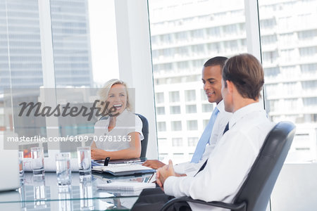 Smiling businesswoman discussing with colleagues