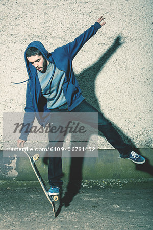 Skater doing truck stand on his board