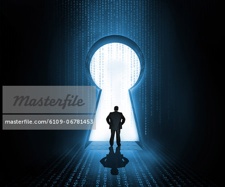 Businessman standing at the keyhole door showing light Businessman standing at the keyhole door showing light