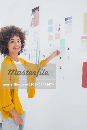 Attractive designer standing in front of material samples