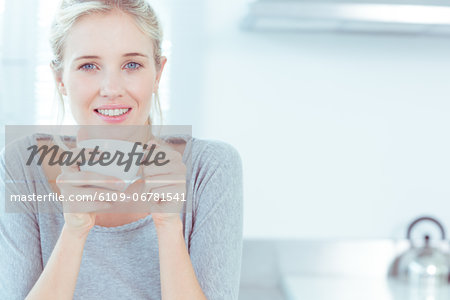 Radiant woman drinking a cup of tea