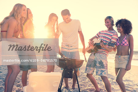 Friends having a barbecue on the beach