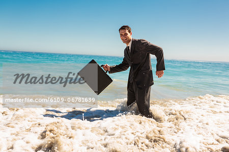 Attractive businessman gesturing in the sea