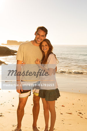 Couple standing and embracing on the beach