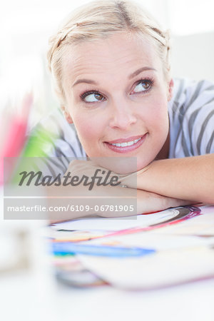 Happy designer posing on her desk