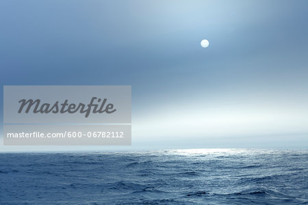 The Atlantic ocean illuminated off the coast of Nova Scotia in fog with the sun shining through. The Atlantic ocean illuminated off the coast of Nova Scotia in fog with the sun shining through.