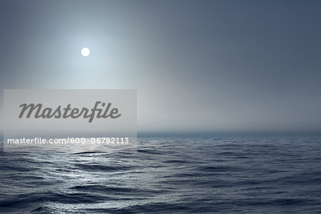 The Atlantic ocean illuminated off the coast of Nova Scotia in fog with the sun shining through. The Atlantic ocean illuminated off the coast of Nova Scotia in fog with the sun shining through.