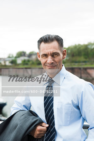 Portrait of mature businessman outdoors, smiling at camera, Mannheim, Germany