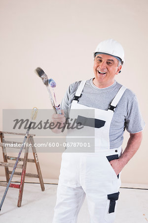 Portrait of Painter with Paint Brush and Roller, Studio Shot