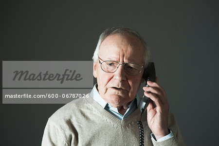 Elderly Man Talking on Phone in Studio