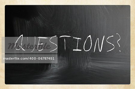 "questions" handwritten with white chalk on a blackboard