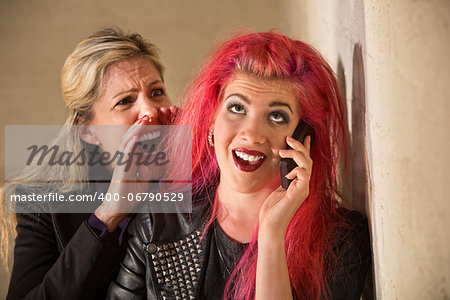 Mature woman yelling to ear of teenager on phone