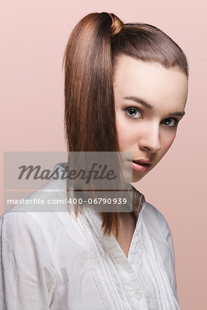close-up portrait of pretty young girl with brown hair, ponytail on the right and white shirt