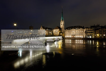 Illuminated Fraumunster Church and River Limmat in Zurich, Switzerland