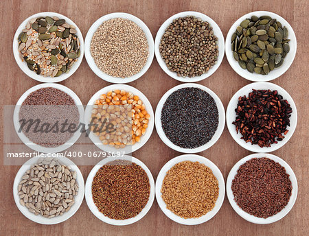 Seed food selection in porcelain bowls over papyrus background.