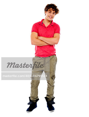 Handsome young guy looking at you. Smiling with folded-arms