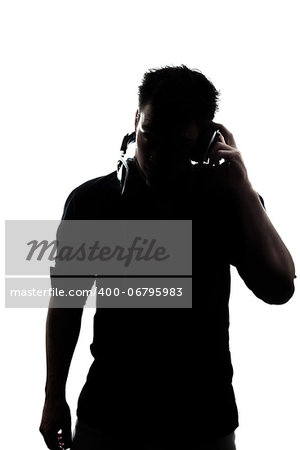 Male in silhouette listening to headphones isolated on white background