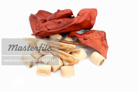 dog snacks, chew sticks and beef ears on white background