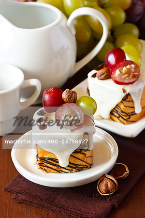 Nut cake decorated with grape and chocolate.