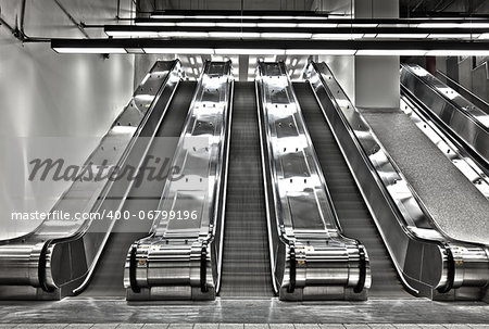 There is a long exposure picture using HDR technique. It show a bit of movement and motion. the stairs are blurry and there is no people in this scene. This was shot in the Montreal metro (subway).