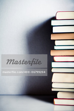 Very high stack of books on a table