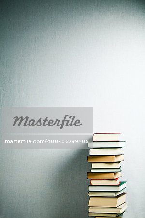 Very high stack of books on a table