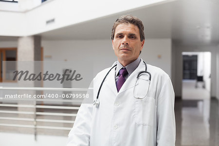 Doctor looking serious in hospital corridor