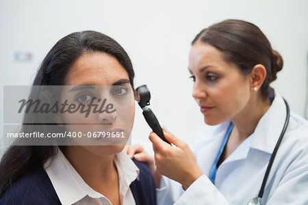 Patients ear being checked by doctor using otoscope in hospital