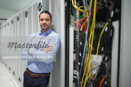 Man leaning against server locker in data center