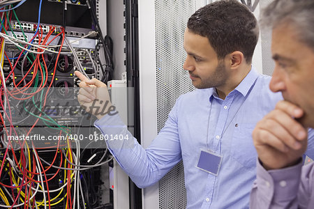 Technicians fixing wires in data center