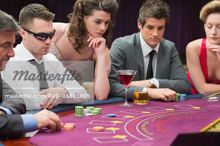 People around the poker table in casio