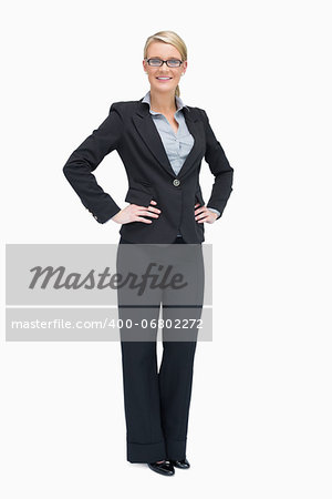 Smiling businesswoman standing her hands on the hip
