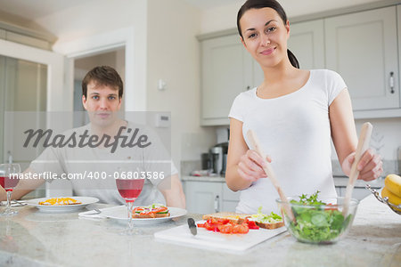 Smiling couple having lunch in kitchen at home