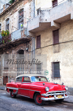 Red vintage American car parked on a street in Havana Centro, Havana, Cuba, West Indies, Central America