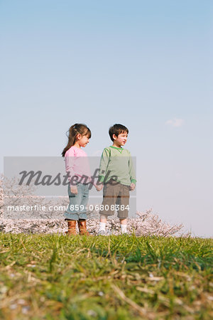 Children holding hands on grassland