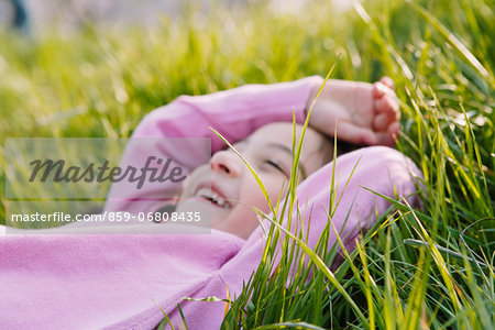 Young girl smiling on grassland