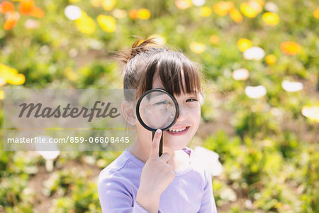 Young girl with magnifying glass