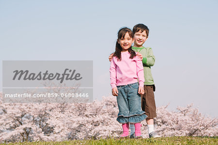 Children on grassland smiling at camera