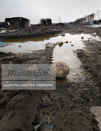 Abandoned ball in burnt out wasteland, Saint Denis, France Abandoned ball in burnt out wasteland, Saint Denis, France