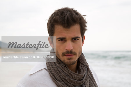 Head and Shoulders Portrait of Young Man at Beach, Sardinia, Italy