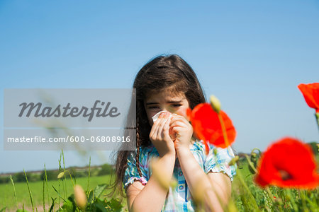 Girl Blowing Nose in Flower Field, Mannheim, Baden-Wurttemberg, Germany