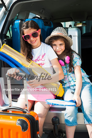 Portrait of Sisters in Trunk of Van Getting ready for Vacation, Mannheim, Baden-Wurttemberg, Germany