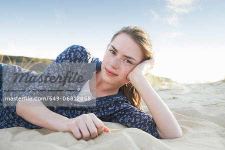 Teenage girl lying on beach