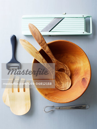 Wooden salad bowl and kitchen utensils